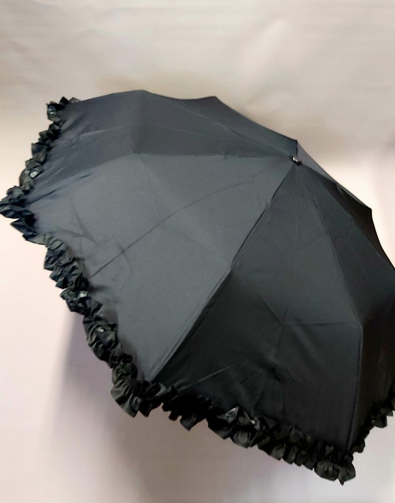 Parapluie Chantal Thomass mini pliant anti uv à 95% noir automatique à volant noir, élégant et solide