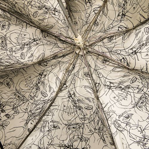 Parapluie JP Gaultier pliant automatique noir doublé argent avec un motif de visages et silhouette par Cocteau, pliant et robuste